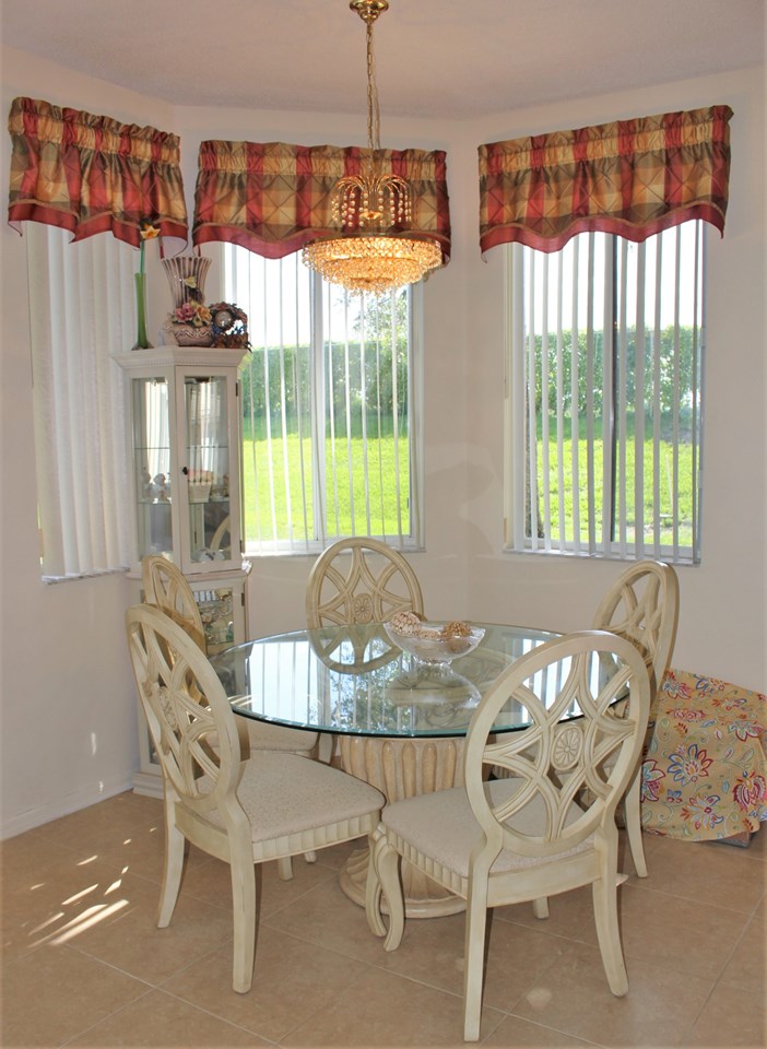 eat-in kitchen area, bar stools and a formal diningroom.... one of three eating/entertaining areas in this graciously appointed home....